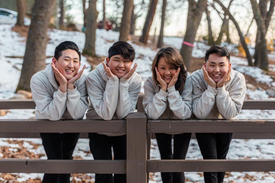 Justin Chai (far right) with his brothers Brandon (far left), Dylan (right) and mother Suzanne Chai.