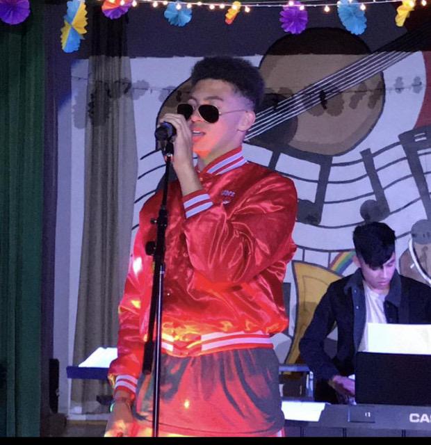 Jarret belts out a song during a performance in front of his high school peers, parents and faculty. After giving up his dream of playing professional basketball, Jarret dedicated himself to singing and songwriting.