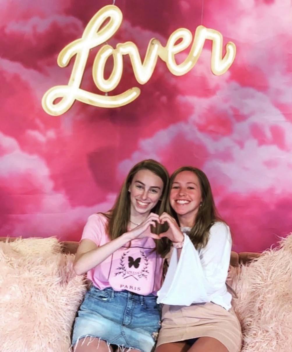 Condolon and her friend create a heart with their hands under the "Lover" sign in Taylor Swift&squot;s New York City, New York, pop-up shop in August 2019. She said she is a big fan of Swift and hopes to meet her one day.