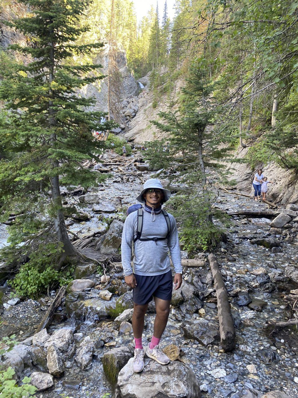 Quincy McAfee stops for a photo while crossing a rocky bank on a hike in Salt Lake City, Utah, on July 19. McAfee ventured on a road trip with Pepperdine Baseball alum Cory Wills this summer. Photo courtesy of Quincy McAfee