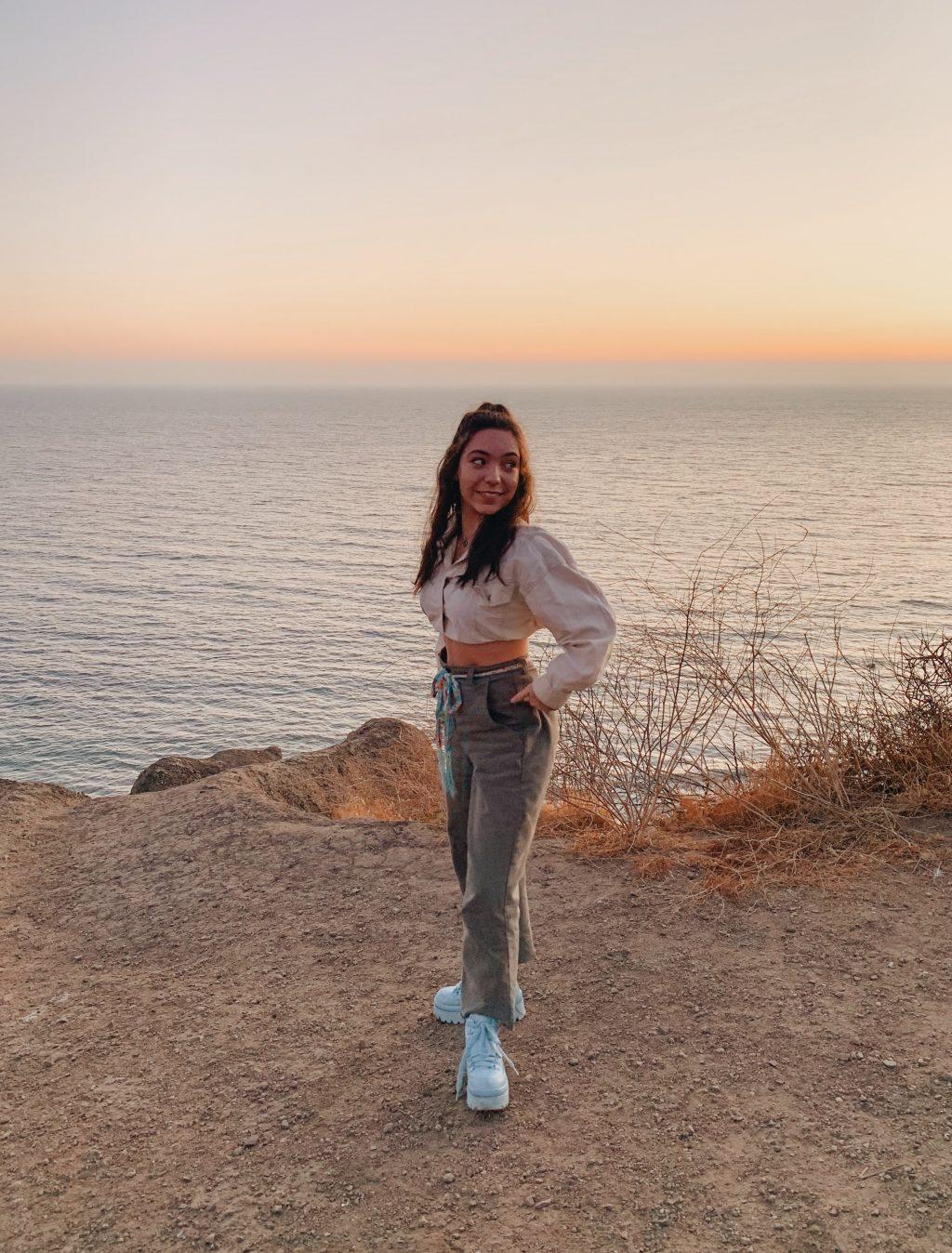 First-year Chloe McLeod poses at the beach during sunset. McLeod said a reason she chose Pepperdine was its proximity to the ocean. Photo courtesy of Chloe McLeod