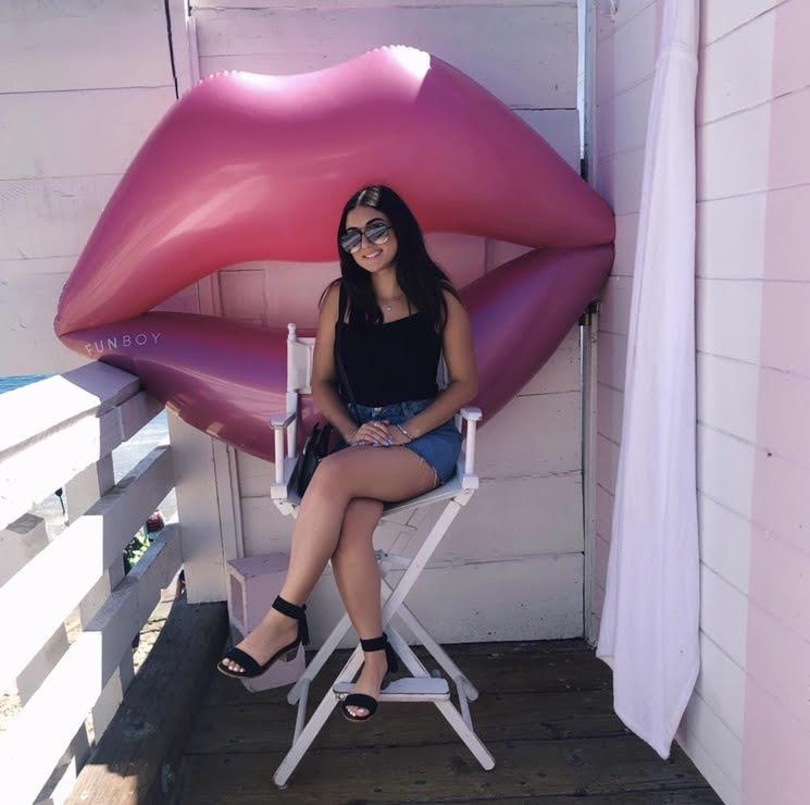 Solakian poses in front of a giant lips pool float on the Malibu Pier while spending the day there in September 2019. She said she likes to drive down from her home in Northridge to eat and enjoy the ocean views.