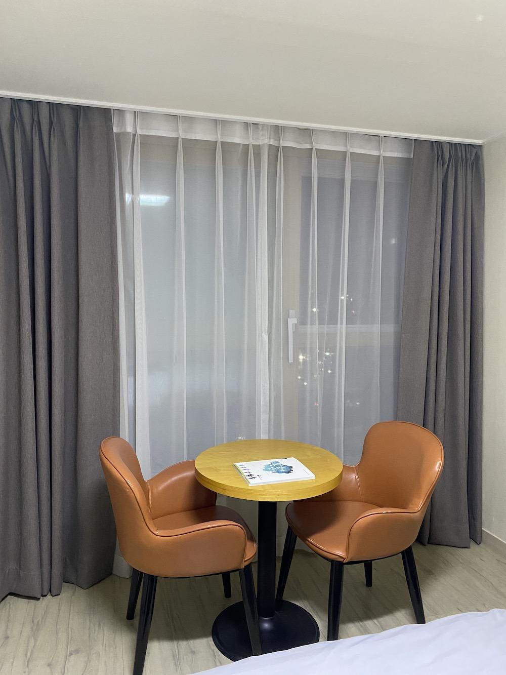 The hotel room for quarantining foreign travelers shows a view of the city's night traffic behind the window curtain. I entered the hotel room close to 10 p.m., which was approximately six hours after my plane landed.