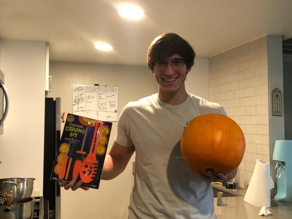 Senior Jack Mullen receives his pumpkin from the Board in the mail and is ready to start carving his design. When classes are on campus, Board event planner Samuel Poe said the Board puts on lots of events, such as Coffee House and movie festivals. Photo courtesy of Samuel Poe