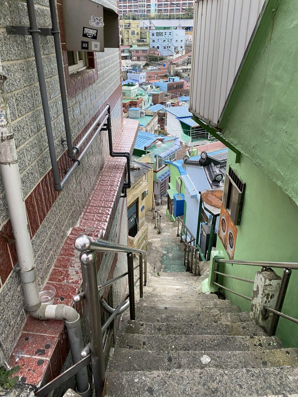The stairs at Gamcheon Culture Village in Busan form a zigzag pathway with added handrails between colorful walls. Although this village is typically bustling with tourists and activities, it was much quieter and vacant when I visited Oct. 4.
