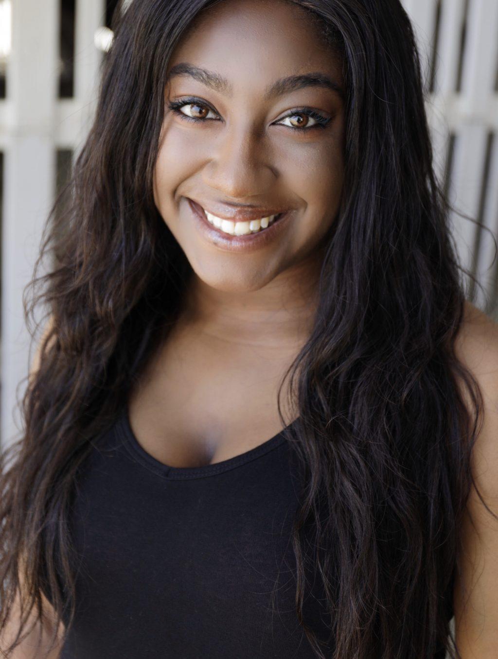 Junior Karese Frizell smiles for her headshot for the theater's performance. The actor brought the Black-empowering, charismatic and beautiful Shameka to life.