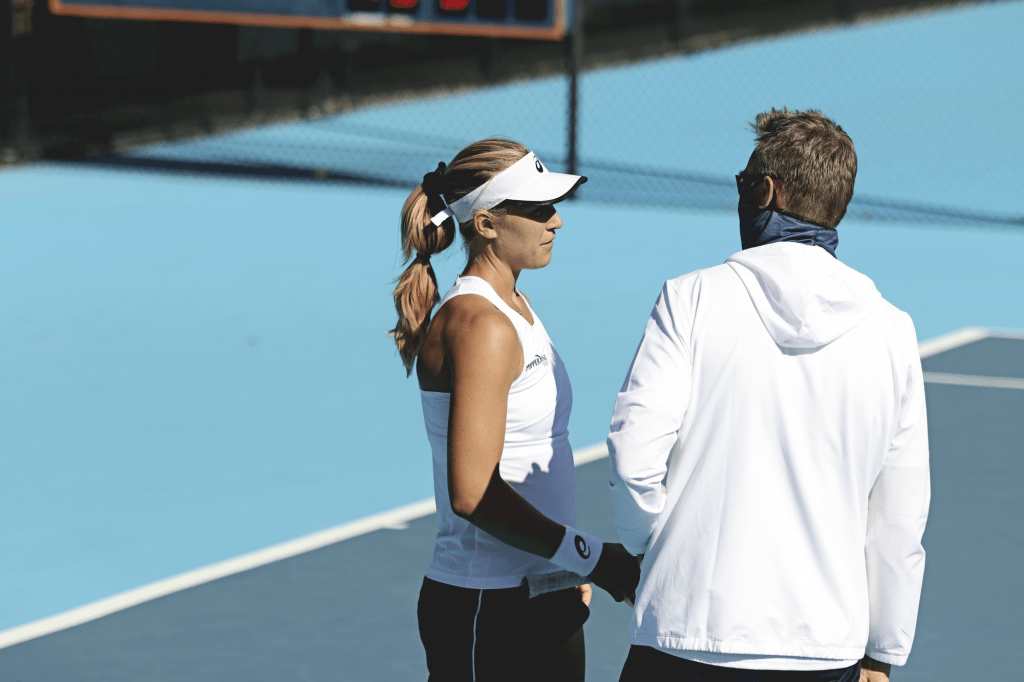 Pepperdine Head Coach Per Nilsson converses with graduate student Ashley Lahey during Lahey's match Friday against Bunyami Thamchaiwat on court two. Lahey roared back to win the second set after losing the first, but the match went unfinished.
