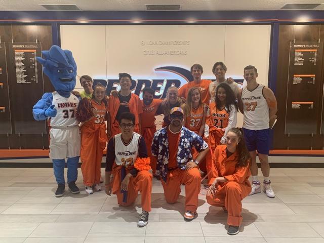 Riley (back row, third from left) poses with the Riptide Rally Crew in Firestone Fieldhouse in October 2019. Riley said the crew was preparing for the Blue & Orange Madness.