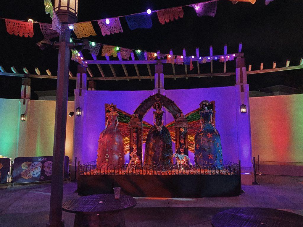 Neon lights shine on a "Día de los Muertos" display located next to the Bride of Frankenstein maze in October 2021. To celebrate the holiday, this upper-level plaza had food, decor, music and more.