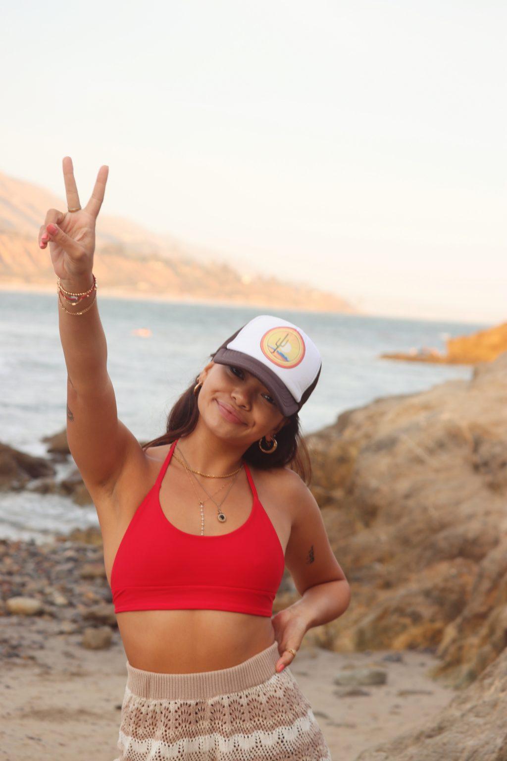 Senior Muriel Lee models the Blakely top in red at Leo Carrillo State Beach in August. Cornelius said she uses her friends as models and photographs them herself.