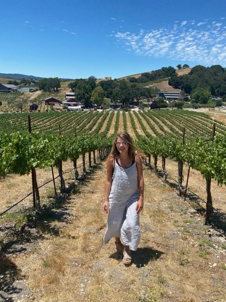 Senior Hattie Pace smiles under the sun in San Luis Obispo, Calif., during a road trip with her roommates in July. Pace said she found this jumpsuit from "Nati," a Malibu boutique. Photo courtesy of Hattie Pace
