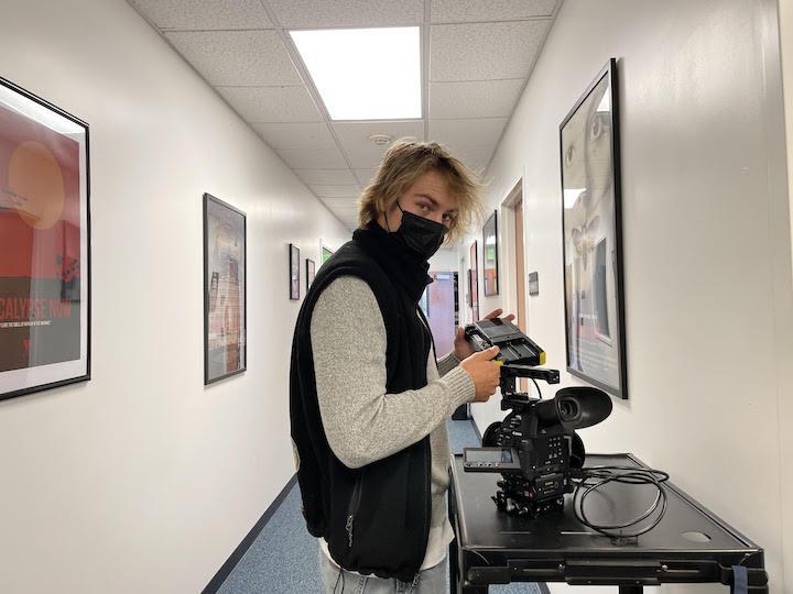 Senior Cade Doggett assembles a breaking news kit in the Center for Communication and Business building. Doggett said he reviews professors who include hands-on learning favorably.