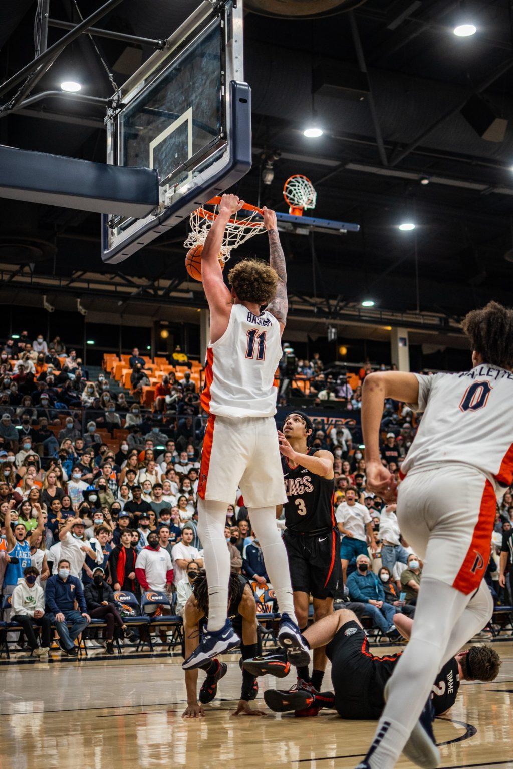 Freshman center Carson Basham slams a dunk as Gonzaga defenders struggle to get up on Feb 16. Basham finished the game with 15 minutes and would be 2 for 3 from the field. Photos by Lucian Himes
