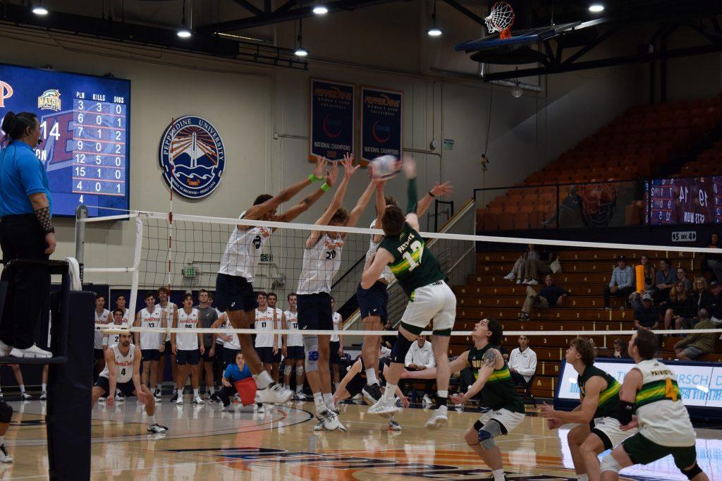 Redshirt sophomore Jacob Steele joins center tackle Austin Wilmot and outside grad student Jaylen Jasper for a triple block in their match against George Mason at Firestone Fieldhouse on March 11.  The Waves finished the game with twelve team blocks.