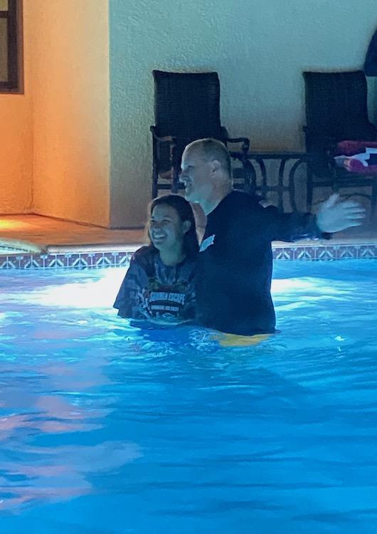 Photo Courtesy Penelope Soler-Sheffield | Pepperdine President Jim Gash baptized Soler-Sheffield after the Well on Dec. 2, 2021 at the Brock House. Soler-Sheffield said watching other students receive baptism inspired her to join, where the gathered crowd cheered her on.
