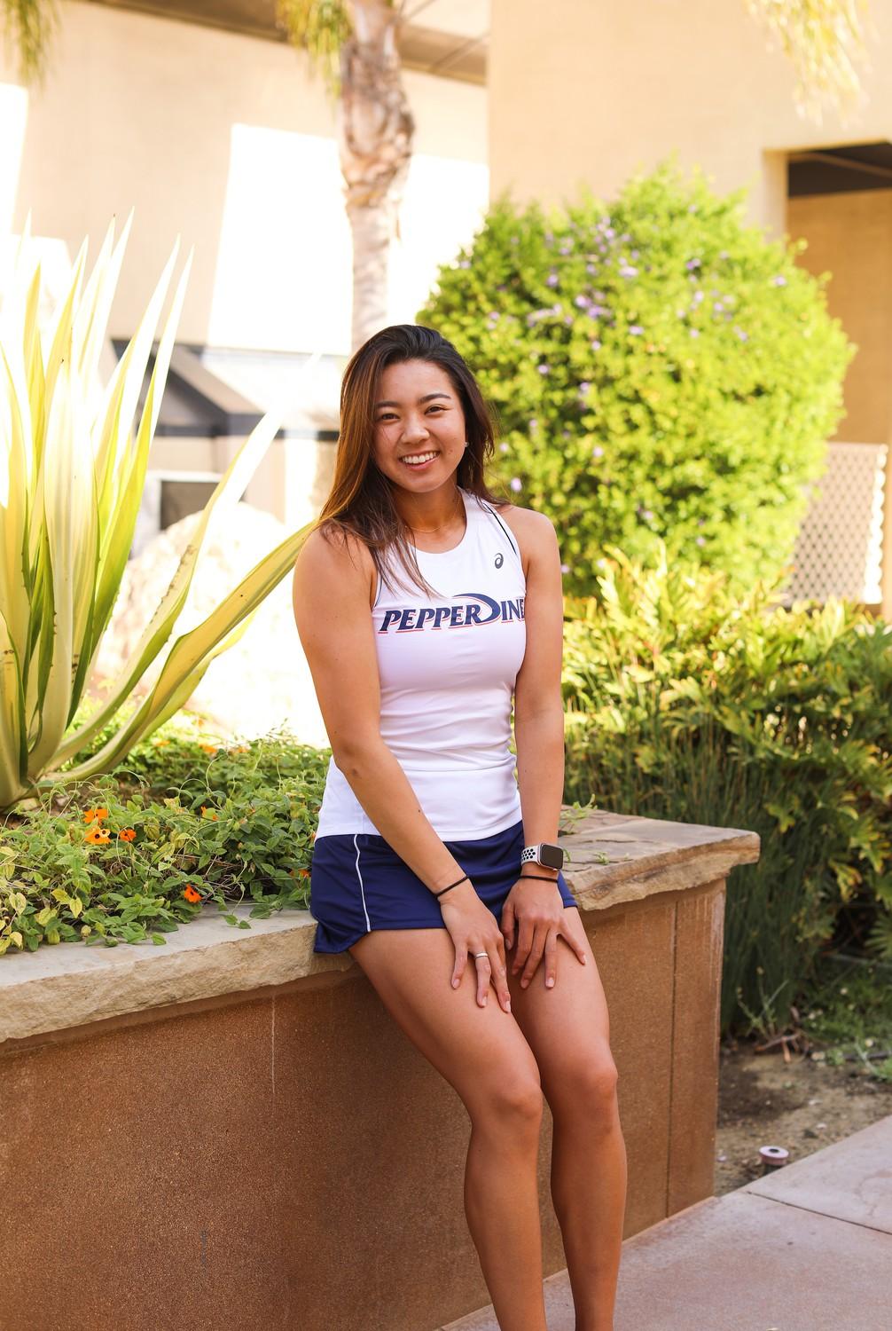 Photo by Caroline Conder | Shiori Fukuda, a student studying for her master’s degree in Global Business at Graziadio and women’s tennis player, sat on a wall outside of Firestone Fieldhouse. Fukuda clinched the winning point for Pepperdine in the 2021 quarterfinals, landing her at the bottom of a celebratory team dog-pile.