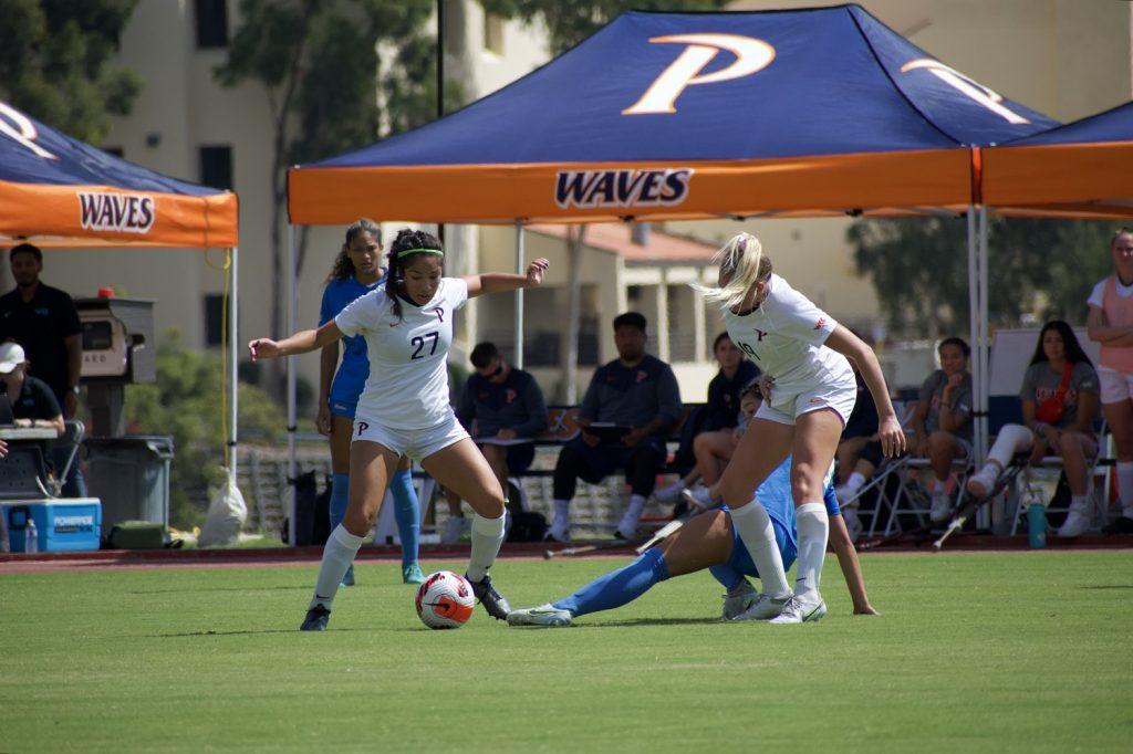 Freshman midfielder Karina Gonzalez fights with a UCLA player for the ball during the Waves 4-0 defeat in Malibu on Sept. 18. Ward said he made a number of substitutions in the second half of the game, in order to give new players opportunities.