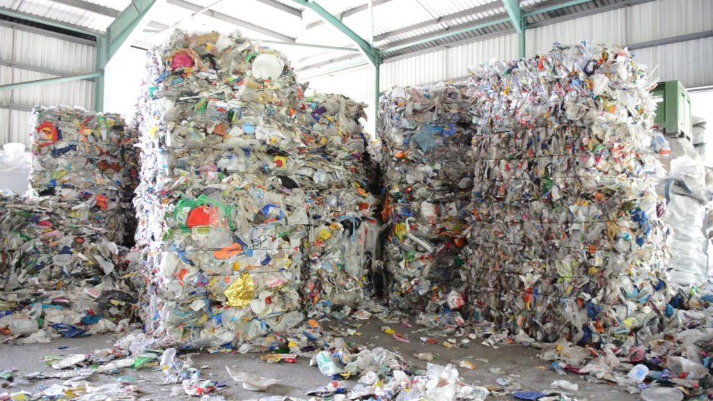 Baled plastic waste sits in a U.S. storage space. The U.S. has scrambled for the past two years to deal with the millions of tons of plastic waste it used to send to China until China cut off the recycling industry in January 2018. Photo courtesy of NPR