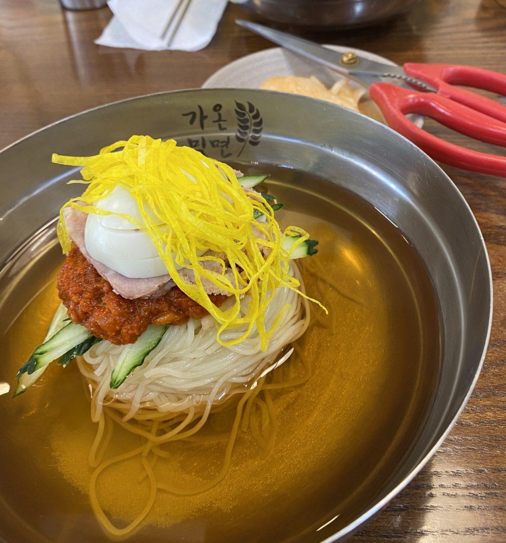 I ate delicious milmyeon soup, made with string-style eggs on top of a boiled egg, meat, spicy sauce, cucumber and milmyeon noodles, at Gaon Milmyeon on Oct. 5. This dish was typically served cold with a cup of warm tea or small soup on the side.