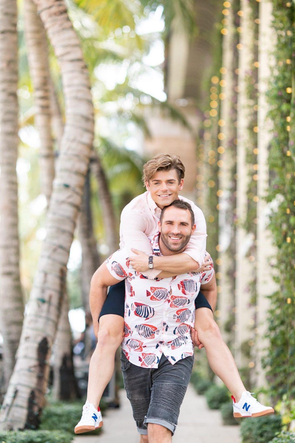 Knight gives Clayton a piggy back ride near Aneé Atelier in Palm Beach, Fla. in March. In July, the couple created an LGBTQ+ channel titled "A Gay in the Life."