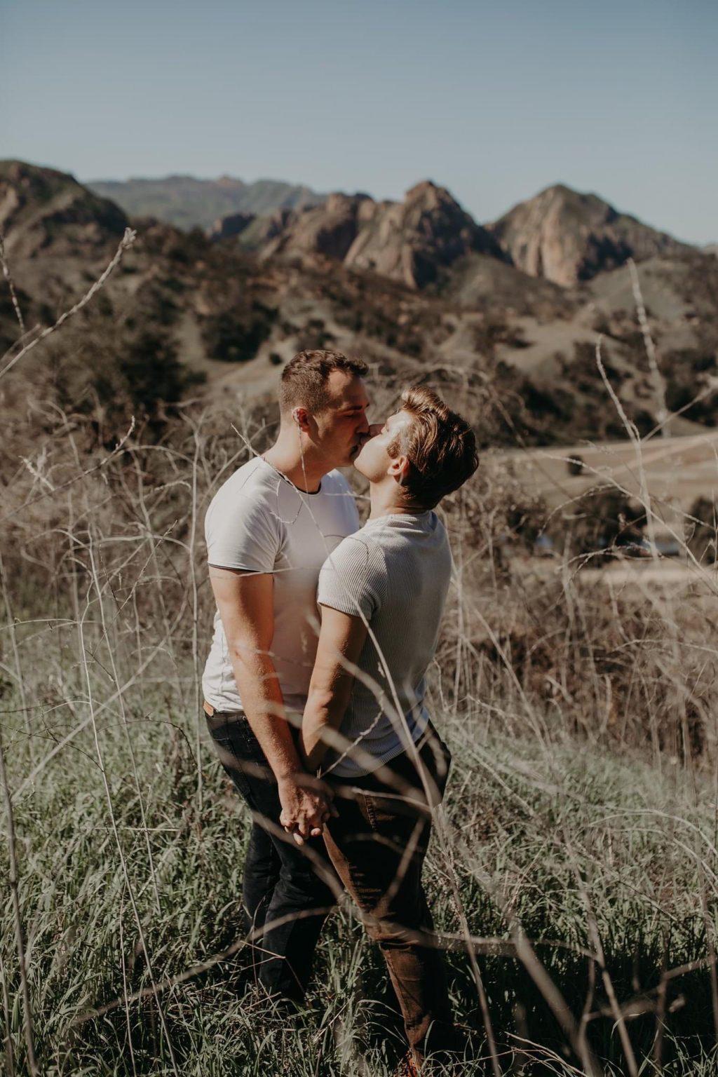 Knight and Clayton kiss in the mountains at Malibu Creek State Park for their engagement photos in February. Knight said they hope to inspire acceptance for all queer people and normalize the queer community in society.