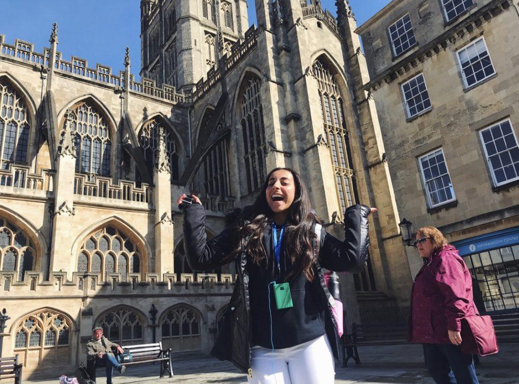 Tadros smiles in front of Bath Abbey cathedral in Bath, England, in April 2018. Tadros’ high school choir group traveled to Europe every two years and performed in churches and cathedrals.
