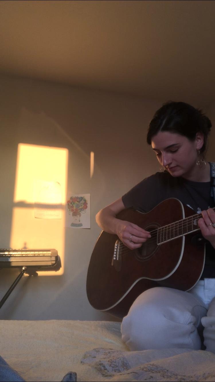 Sullivan plays a song on the guitar in her home in Fredericksburg, Va., in April. She said she was insecure about sharing her music in high school but opened up musically once she felt comfortable at Pepperdine. Photo courtesy of Lindsey Sullivan