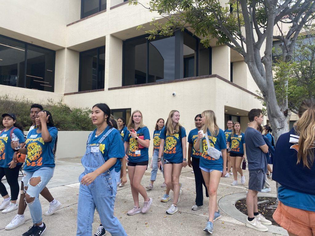 Students walk to the shuttles in the main parking lot. Most groups this year volunteered off-campus. Photo by Tanya Yarian