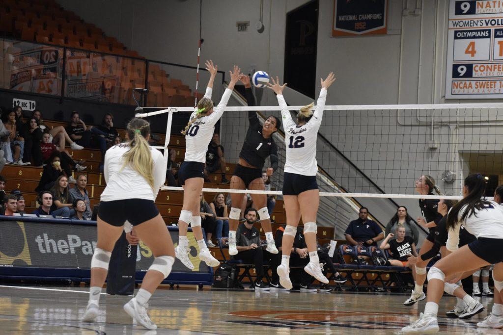 Freshman outside hitter Emily Hellmuth and junior middle blocker Meg Brown square up to block an attack from the Tigers. Hellmuth and Brown had 11 and nine kills respectively.