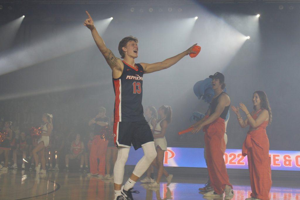 Freshman basketball player Cord Stansberry cheers with the crowd at Firestone Fieldhouse Oct. 14. Basketball players participated in dunk contests at Blue and Orange Madness. Photo by Chloe Chan