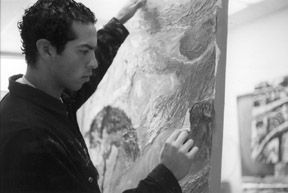 Keven Estrada works on his piece '9 Lives.' Photo/Micah Kafka