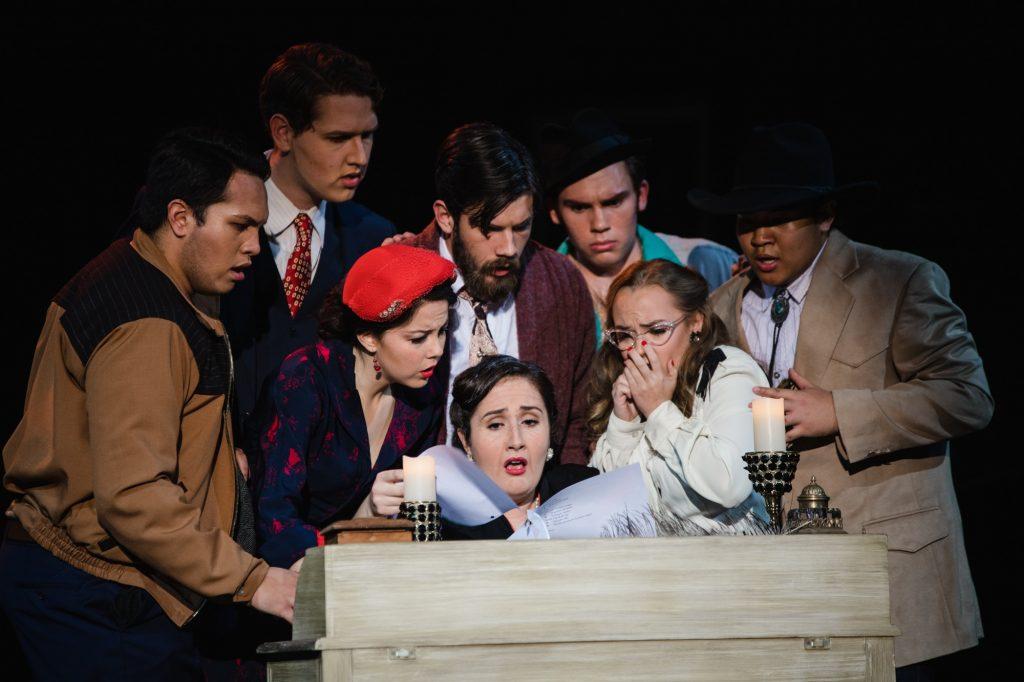 The cast of "Gianni Schicchi" gathers around Zita (Hannah Miller) as she reads the will of their late relative. The uniquely small size of the "Schicchi" cast provided extensive learning opportunities for the students and fostered a tight community.