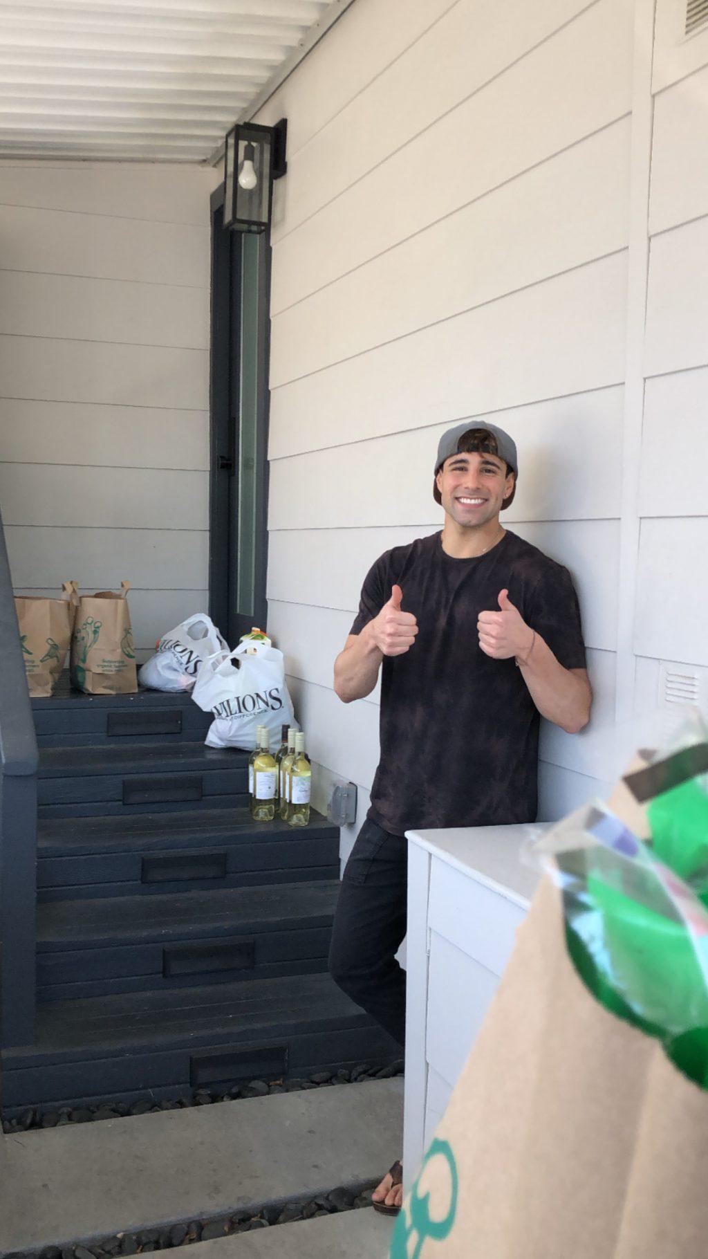 Zeke Bongiovanni delivers four bags of groceries from Whole Foods and Pavillions to his client's front steps March 21.