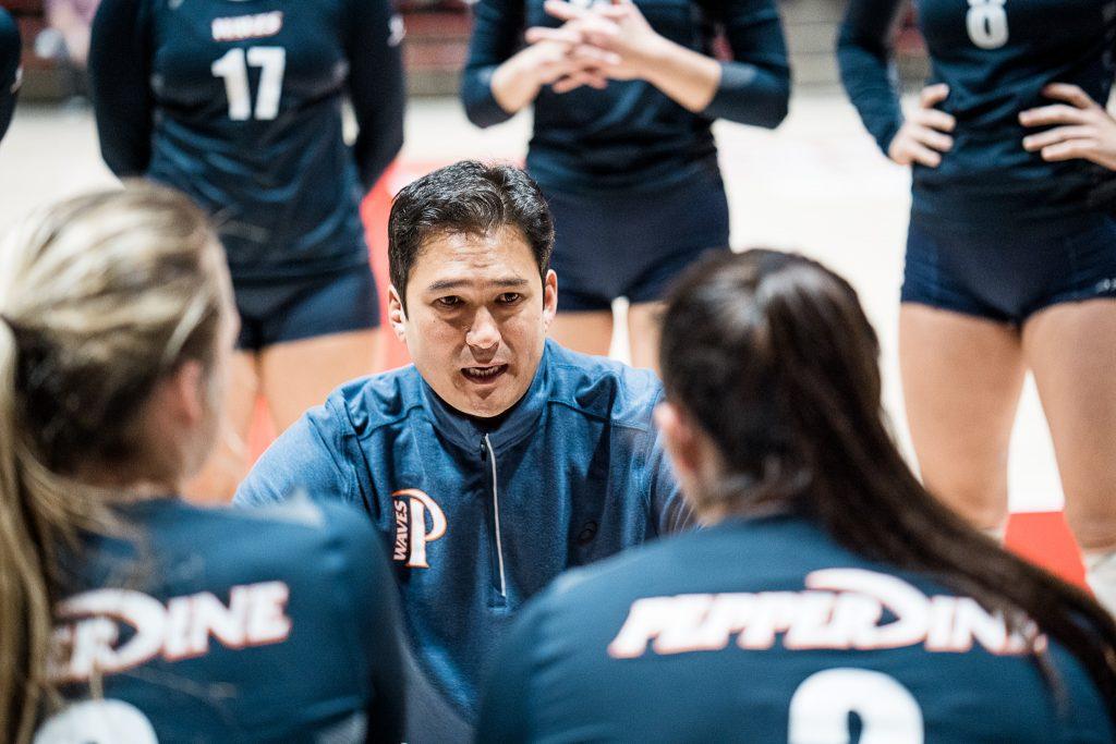 Women's Volleyball Head Coach Scott Wong speaks to his team during a timeout. Wong said the COVID-19 has not affected contact with high school junior and senior recruits, but it has been challenging to make contact with sophomores. Photo courtesy of Mark Burch | Pepperdine Athletics