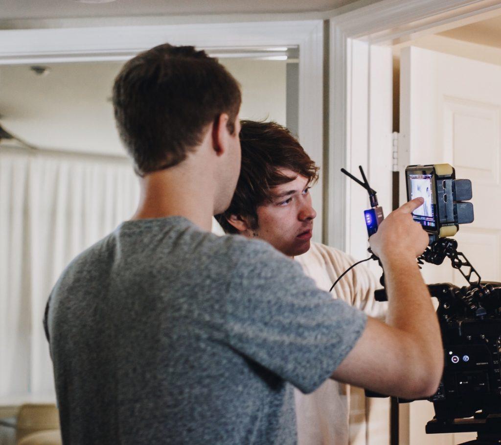Battin (right) and senior Orion Keen (left) analyze a frame in an LED monitor. This picture was taken on the first day of shooting for the film "Self-Absorbed."