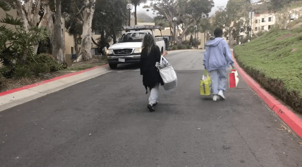 Freshman Kylie Guieb walks on Upper Dorm Road with her mom after they packed up her dorm in E. Pengilly House.