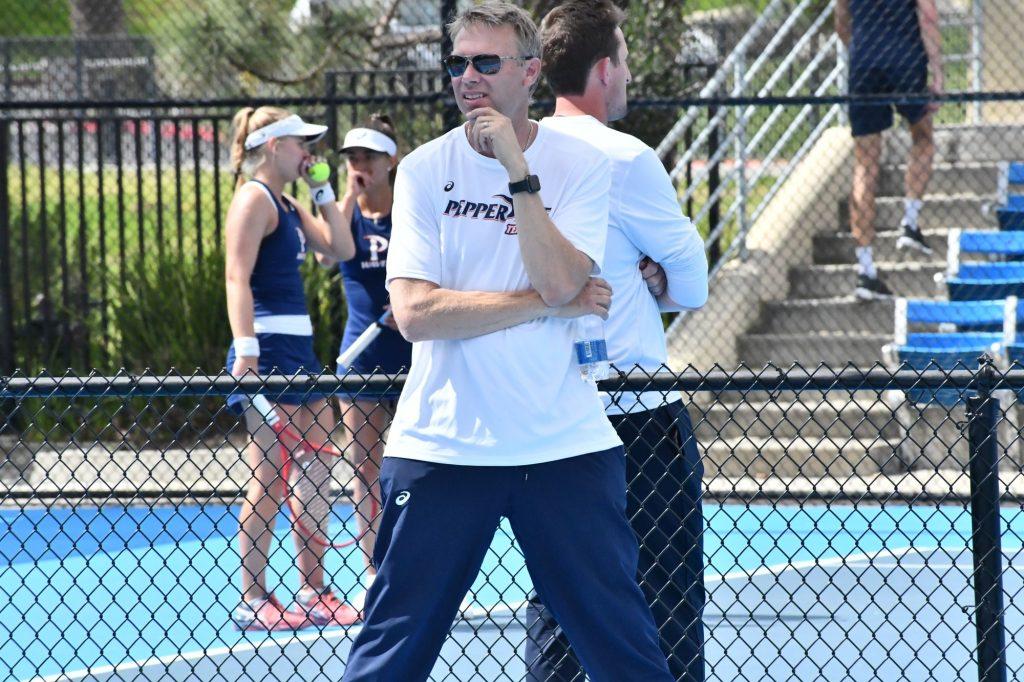 Women's Tennis coaches Per Nilsson (front) and Pete Billingham (back) watch doubles matches at the Ralphs-Straus Tennis Center. Nilsson said that the break from intense training could be positive for tennis players. Photo courtesy of Sarah Otteman | Pepperdine Athletics
