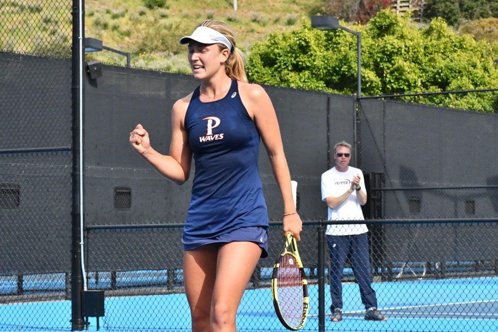 Lahey celebrates her victory in a dual singles match against No. 4 Texas on Feb. 28 in Malibu, as Head Coach Per Nilsson looks on. The Waves would win the match 7–0. Lahey finished the spring season with only one singles loss. Photo courtesy of Pepperdine Athletics