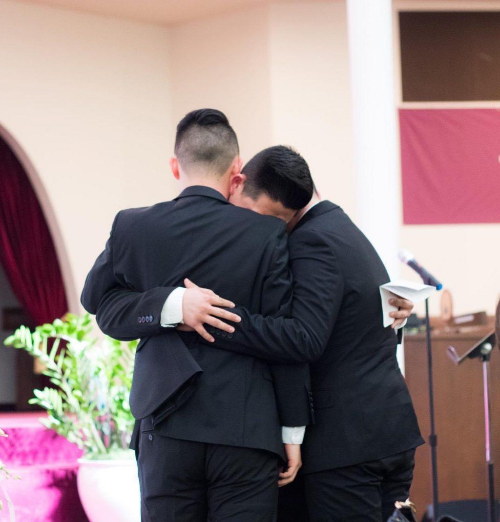 Justin and his brothers Brandon and Dylan embrace each other at their father's funeral.