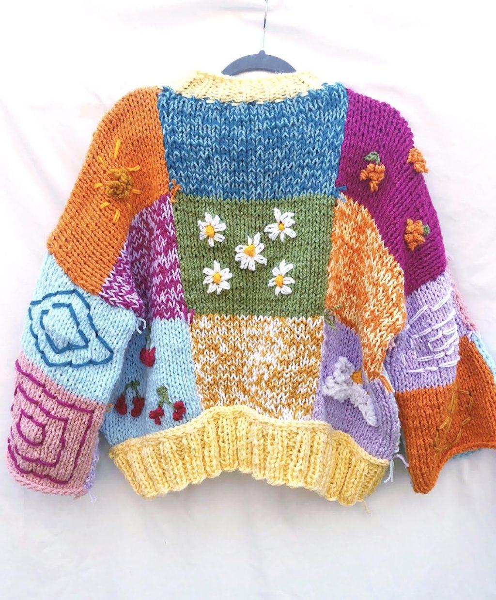 One of Ross' colorful creations hangs in front of a white background. During the extra time Ross had in quarantine, she knitted and designed many sweaters that incorporated bright colors and patterns for a young, fun look. Photo courtesy of Kendall Ross