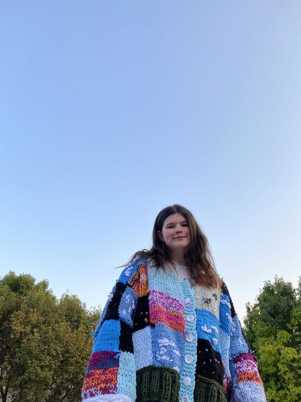 Knitter Kendall Ross displays one of her handmade knit sweaters. She made many new articles of clothing during quarantine to add to her growing business, I'd Knit That. Photo courtesy of Kendall Ross