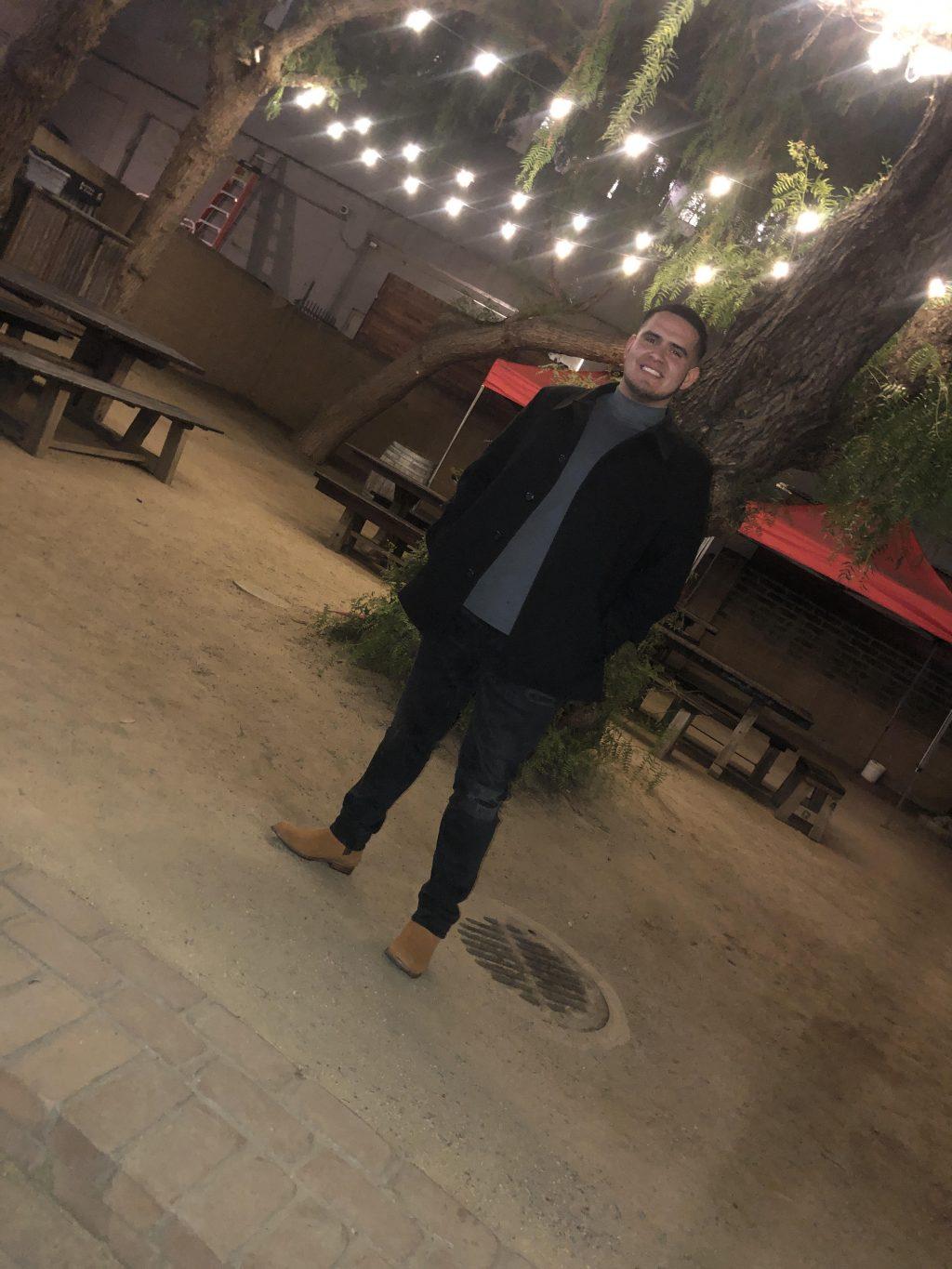 Garcia smiles in front of a restaurant. He said he hopes to make meaningful connections at Pepperdine.