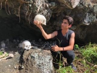Fiji program attendant Brandon Oddo gazes at an unidentified skull before an entrance to a cave during his visit to Fiji. While in the abroad volunteer program, Oddo visited a variety of interactive settings and connected with the locals on a personal level.
