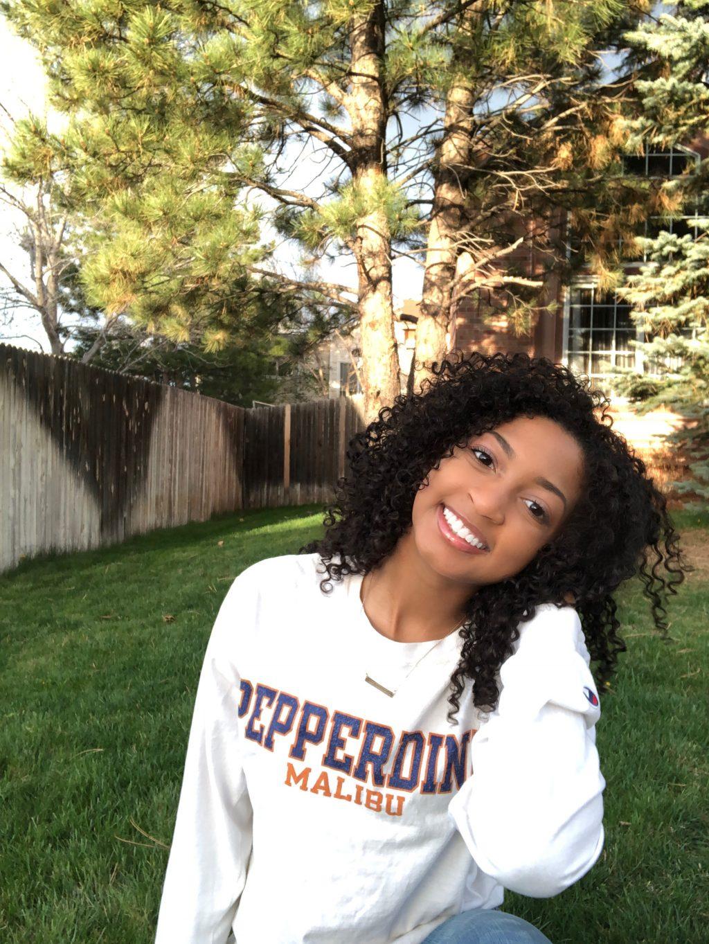 Biology major Pearson smiles, proudly sporting her Pepperdine gear in her backyard. She said she hopes to continue to grow her faith at the University.