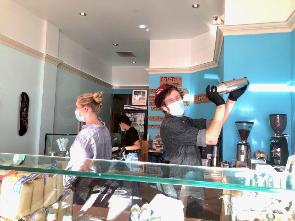 Max Gualtieri — owner of Joules and Watts Coffee, barista and coffee roaster — shakes an iced latte at his pop-up coffee shop.