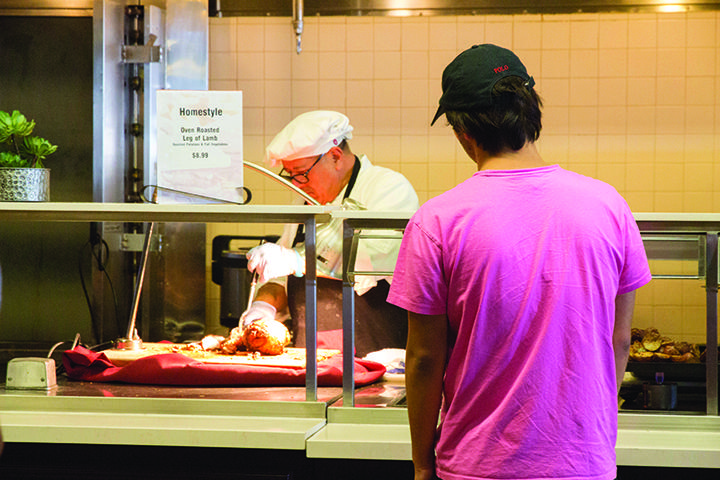 A hungry student watches a Waves Cafe cook prepare a meal. Pepperdine Dining Services announced any meal service for on-campus students will be from Seaver Campus's cafeteria but may provide a few new ways to distribute food. File photo