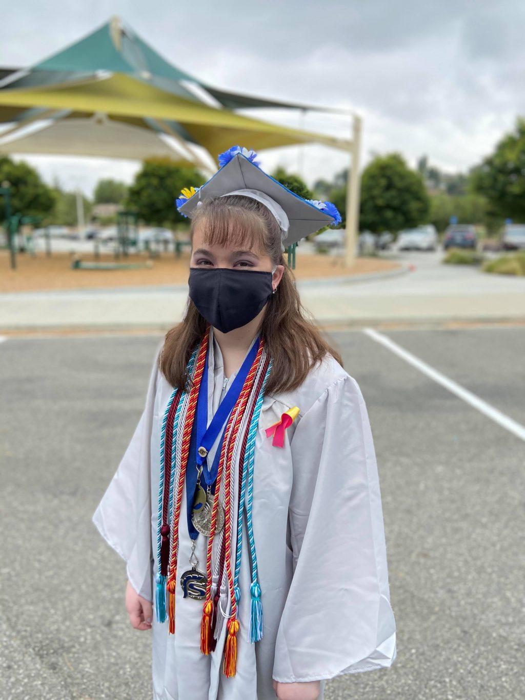 Then-high-school-senior Navia masks up before entering her socially-distant graduation ceremony from her Santa Clarita high school. Students were able to walk through the ceremony but were required to abide by COVID-19 restrictions.