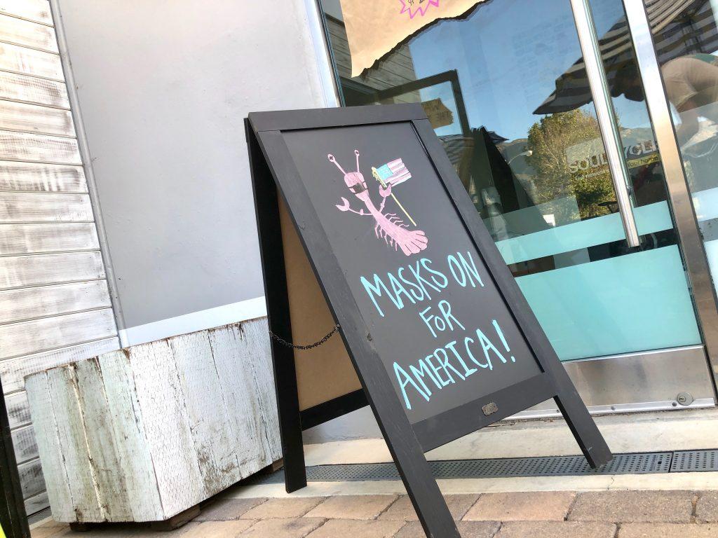 Broad Street Oyster Company displays a sign outside the restaurant asking customers to wear their masks.