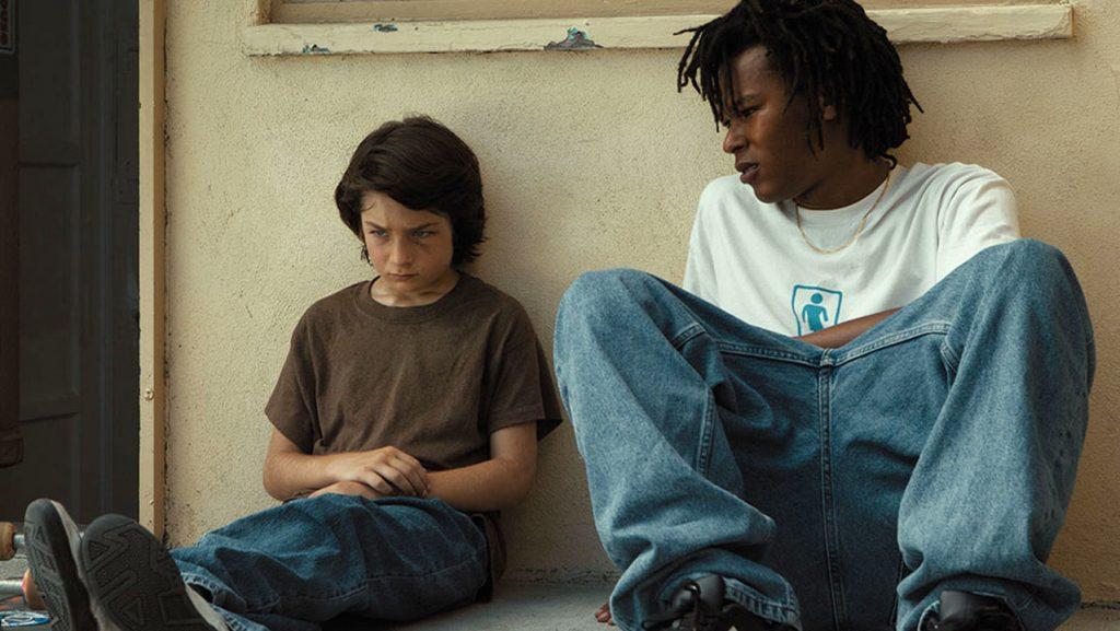 Stevie and Ray sit outside the skate shop where they met. They had a heart-to-heart conversation about life's struggles once the other kids left.