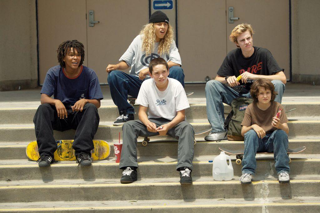 The skateboarders stay seated on the stairs of their favorite skate park after defying a cop's orders to leave.